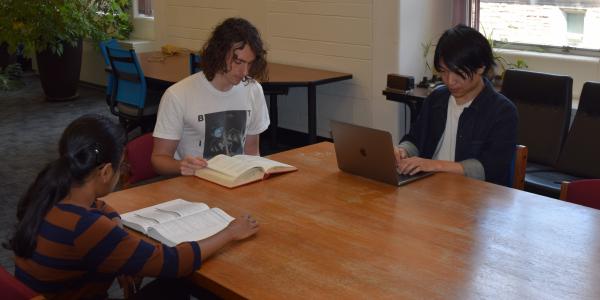 (L-R) Writasree Maitra, J.R. Cruise, and Takuya Okawa at work in the Compton Hall Physics Library