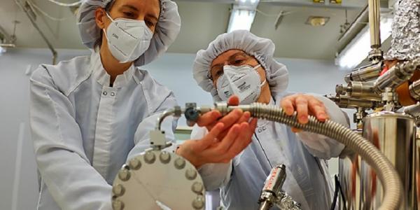 Olga Pravdivtseva, right, helps adjust the extraction manifold apparatus at Johnson Space Center in Houston. (Photo: Alex Meshik)
