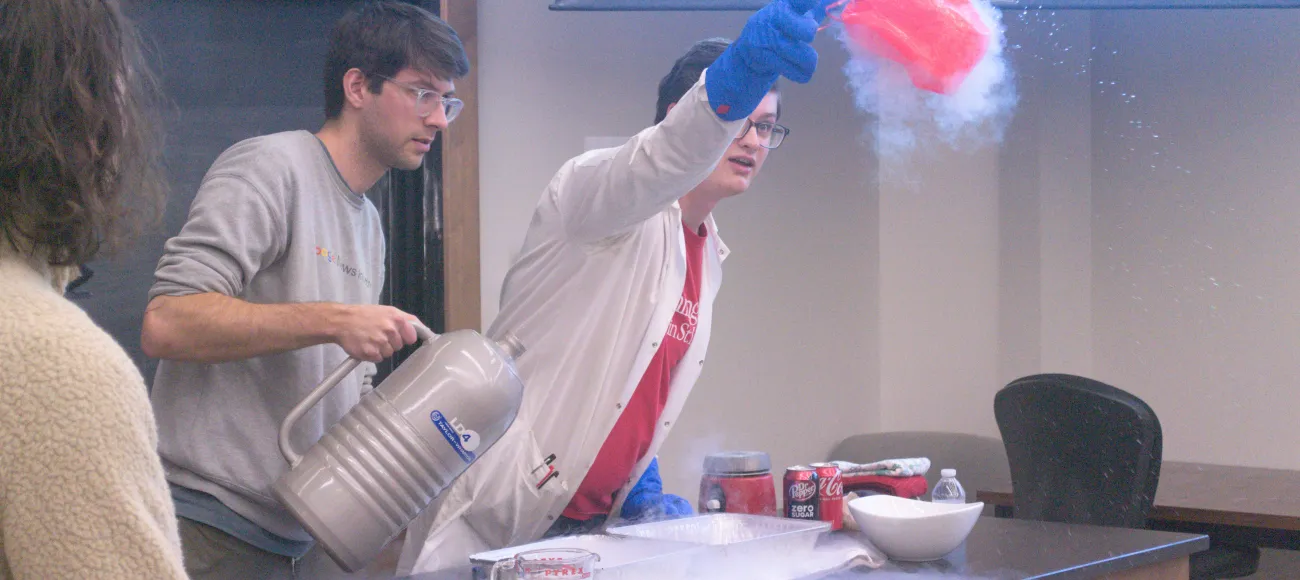 Grad students use liquid Nitrogen to demonstrate how gasses contract when exposed to extreme cold