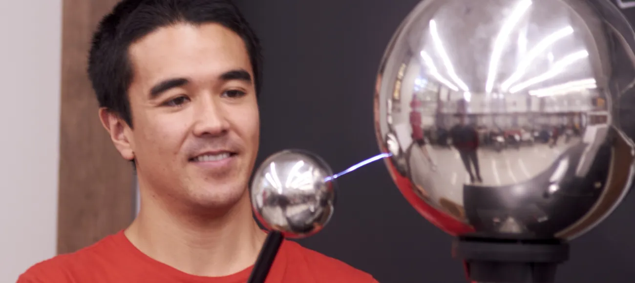 Grad student Bryce demonstrates a Van de Graaff generator at Physics Family Fun Day