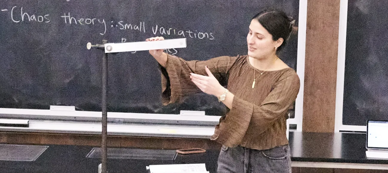 Grad student demonstrates the double pendulum or "chaos pendulum" at Physis Family Fun Day