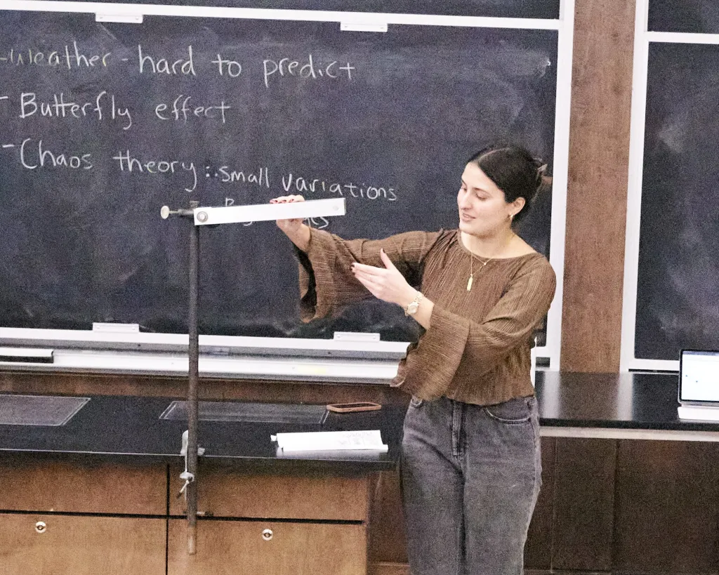 Grad student demonstrates the double pendulum or "chaos pendulum" at Physis Family Fun Day
