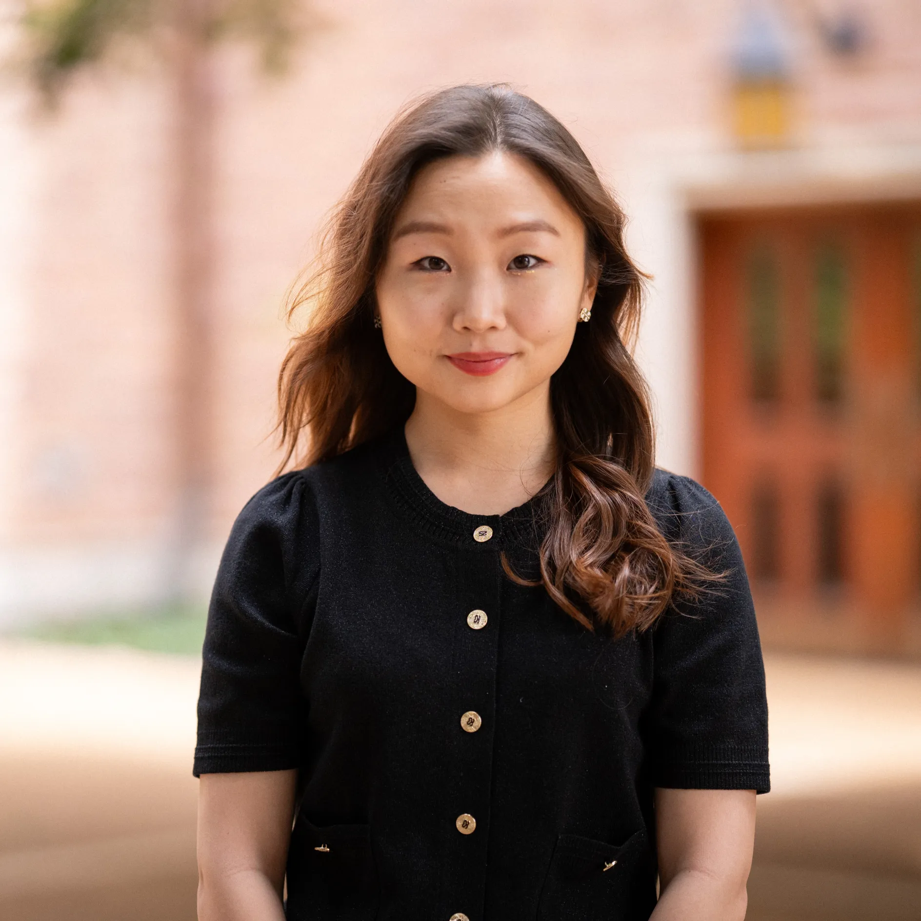 Sohee Chun in front of a building on the Danforth Campus