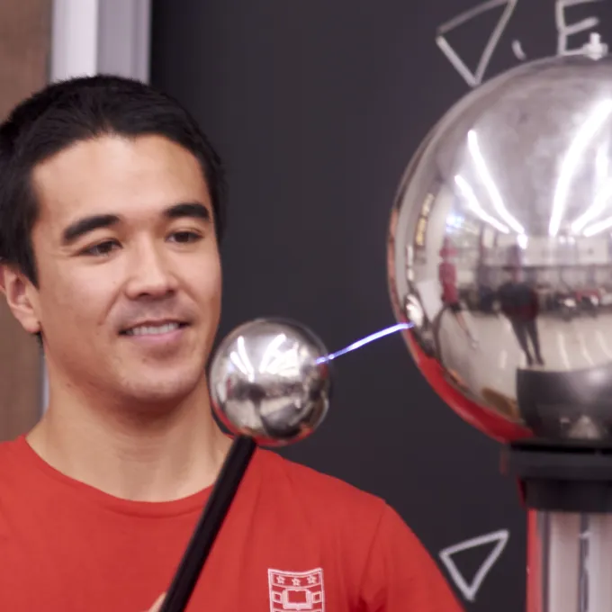 Grad student Bryce demonstrates a Van de Graaff generator at Physics Family Fun Day